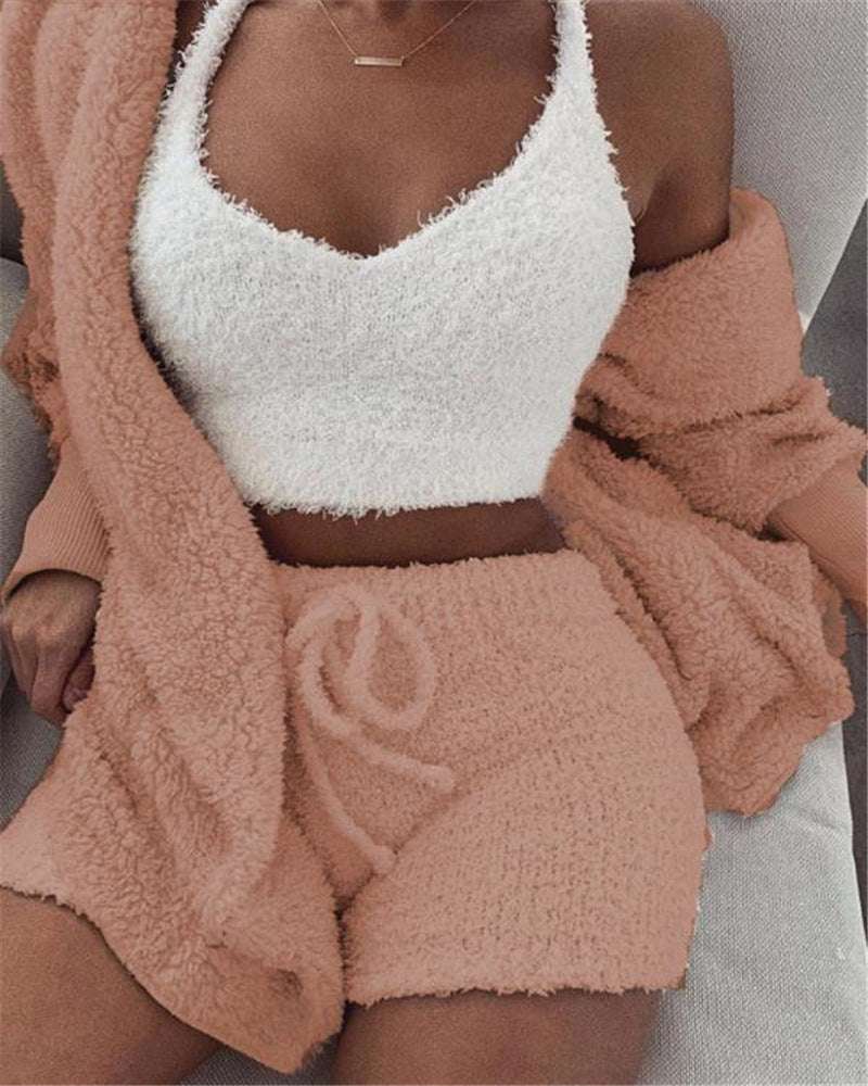 Cozy 3 piece women's sleepwear set featuring a white fuzzy crop top and soft pink shorts with matching cardigan